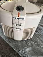 Front view showing Honeywell branding, indicator light, HEPA/Clean and Filter Change slide switches