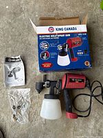 Full kit showing spray gun, paint cup, manual, bagged parts and box