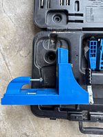 Blue Kreg jig clamped in case interior