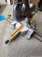 Top view showing 10 in blade, base, miter scale, yellow fence insert and slide rails