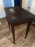 Full view of table angled, shows overall design and finish wear