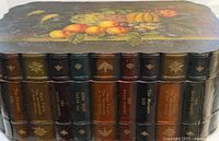 Full view of chest showing painted lid and faux book spines