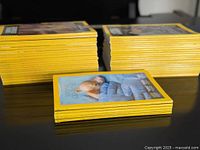 Three stacks of yellow-border National Geographic magazines on table