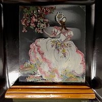 Full view of reverse glass painting on wooden stand