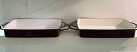 Both enamel pans side by side front view showing exterior color and handles