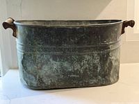 Front view of aged copper boiler tub showing patina and ridges