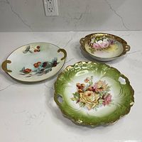 Group shot of three hand-painted porcelain serving dishes