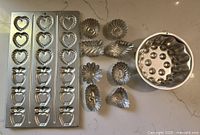 Group shot showing sheet pan, nine small molds and fluted cake mold