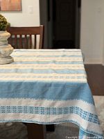 Blue and white woven stripe tablecloth on dining table