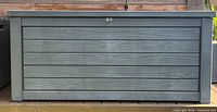 Front view of closed Keter gray wood-look deck box