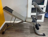 Side profile of Linex adjustable bench showing backrest, seat, curl pad and frame