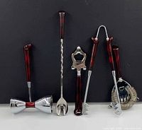 Front view of five bar tools with cranberry Bakelite handles