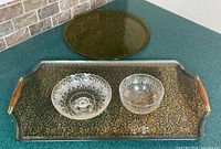 Rectangular paisley tray with two clear glass bowls and round amber tray behind