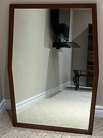 Front view of full mirror showing wooden frame and angled sides