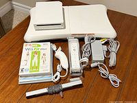 All items laid out: console, Balance Board, controllers, cables, sensor bar, stack of games