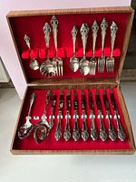 Full view of flatware in open wood chest