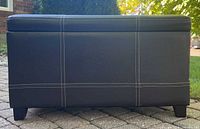 Front view of dark brown rectangular ottoman with contrast stitching