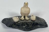 Front view of three gull figures on stone base
