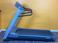 Side profile of Precor treadmill showing console, handrails and frame