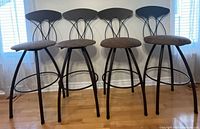 Front view of four matching metal bar stools