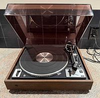 Front view of Dual 1249 turntable with dust cover open