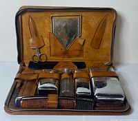 Open case overview showing all contents secured by leather straps