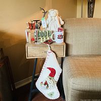 All ten Christmas décor items arranged on side table and hanging from chair for full view