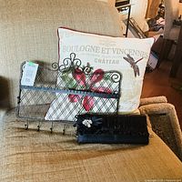 All three items – pillow, clutch and jewelry organizer – displayed on chair