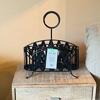 Overall view of black metal dish and cutlery caddy on table