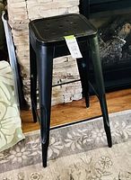 Front view of black metal bar stool