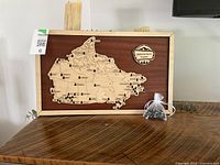 front view of wooden Canadian National Parks tracker map with accessory bag