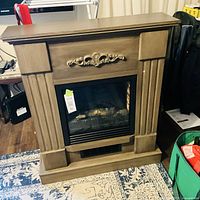 Full view of electric fireplace heater with mantel