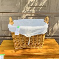 Overall view of wicker basket with handles and liner
