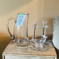 Entire five-piece clear glass set on table