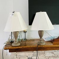 Both lamps on mantel showing bases, shades, cords