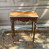 Full view of small rectangular wooden side table showing top, legs and apron