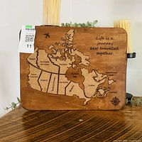 Front view of wood board showing cork map of Canada, engraved text and measurements tag