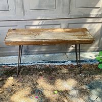 Full view of rectangular wooden table showing wood top and metal hairpin legs