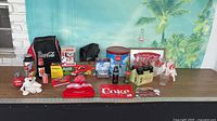 Wide view of entire Coca-Cola memorabilia lot on table