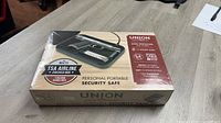 Front view of sealed Union Safe Company portable security safe packaging