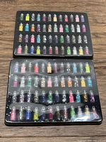 Two sealed trays stacked showing all glitter vials