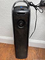 Front view of Holmes tower air purifier showing grille, control knob and cord
