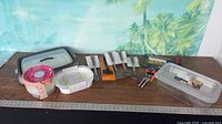 Full lot overview on tabletop showing containers, utensils, small gadgets