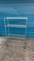 Full front view of chrome four-tier wire shelf rack