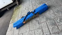 Full view of blue carry bag containing canopy