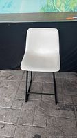 Front view of white vinyl bar-height chair on black metal sled base