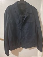 Front view of navy Banana Republic jacket on hanger