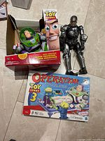 Group shot of Buzz Lightyear box, GI Joe figure, and Operation Toy Story 3 game box