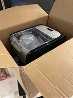 Pasta maker inside opened cardboard box