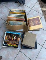 Overall lot showing box of vinyl records and several loose LPs